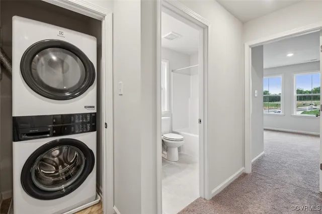 a view of a hallway with washer and dryer