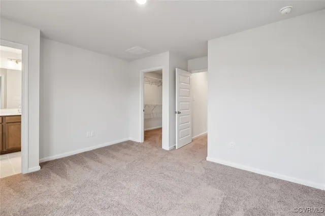 a view of an empty room and closet area