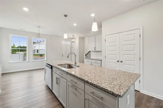 a kitchen with counter top space and wooden floor