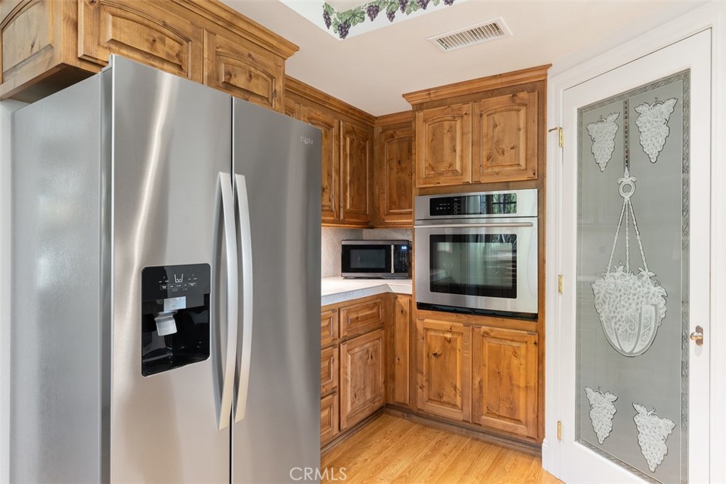 39460 Hilt Road Temecula, CA 92591 - Photo 20 of 74 a kitchen with stainless steel appliances a refrigerator and a cabinets