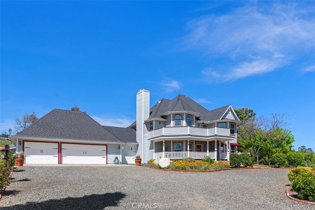 39460 Hilt Road Temecula, CA 92591 - Photo 2 of 74 a front view of a house with a garden and lake view