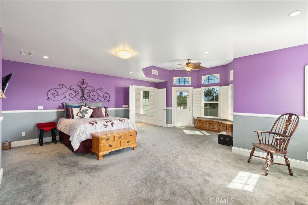 39460 Hilt Road Temecula, CA 92591 - Photo 30 of 74 a spacious bedroom with a bed and a chair