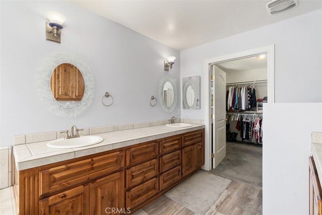 39460 Hilt Road Temecula, CA 92591 - Photo 35 of 74 a spacious bathroom with a double vanity sink double and a mirror