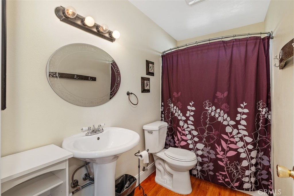 39460 Hilt Road Temecula, CA 92591 - Photo 61 of 74 a bathroom with a toilet a sink and a mirror