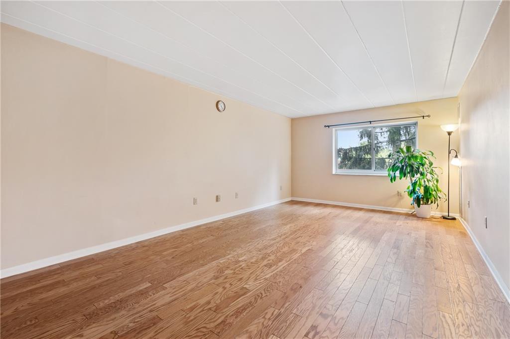 5 Bayard Road, Unit 221 Pittsburgh, PA 15213 - Photo 6 of 20 an empty room with wooden floor and windows