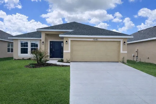 a front view of house with yard and outdoor seating