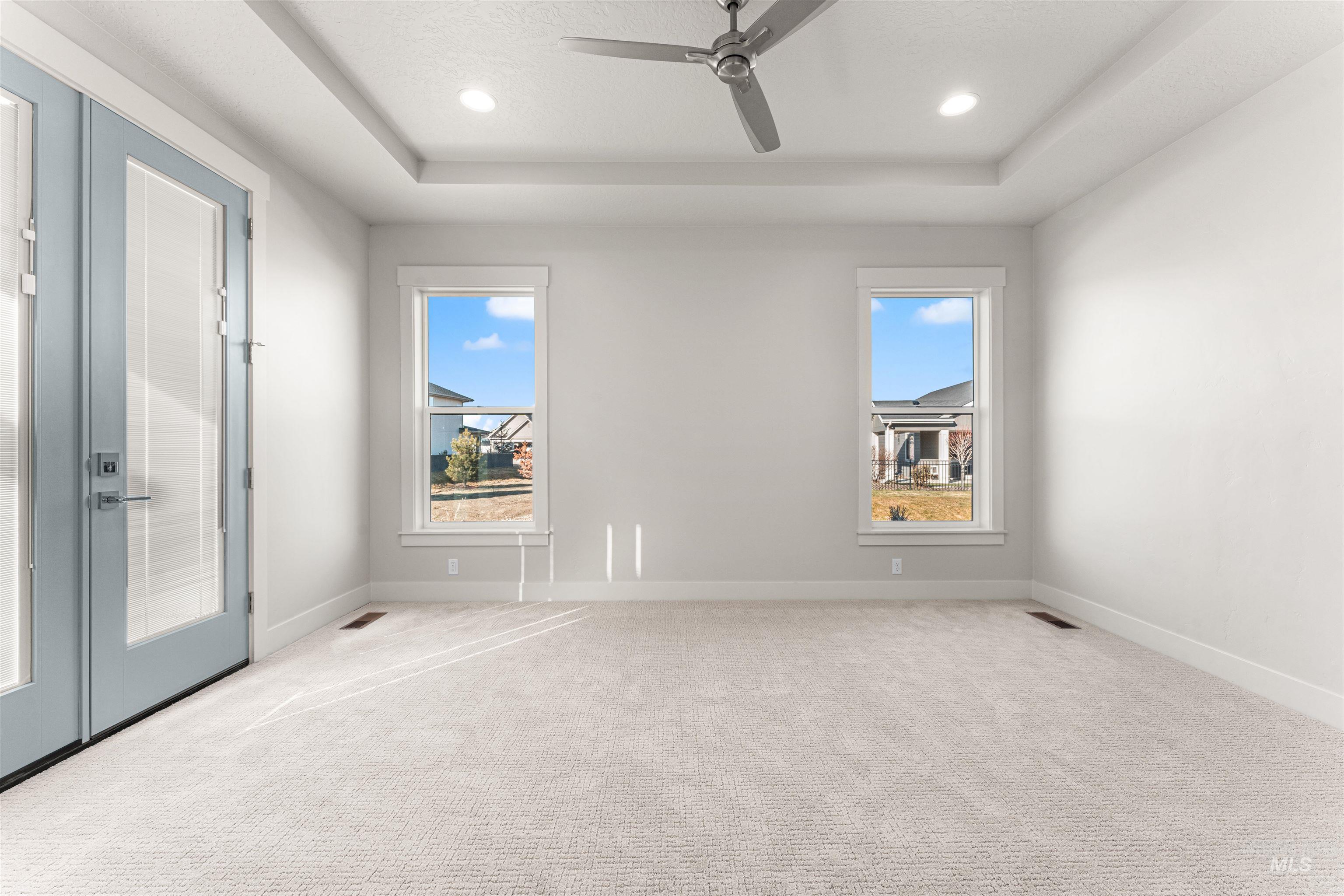 8080 Tandy Cv Street Middleton, ID 83644 - Photo 14 of 35 Carpeted spare room with a tray ceiling, ceiling fan, and recessed lighting