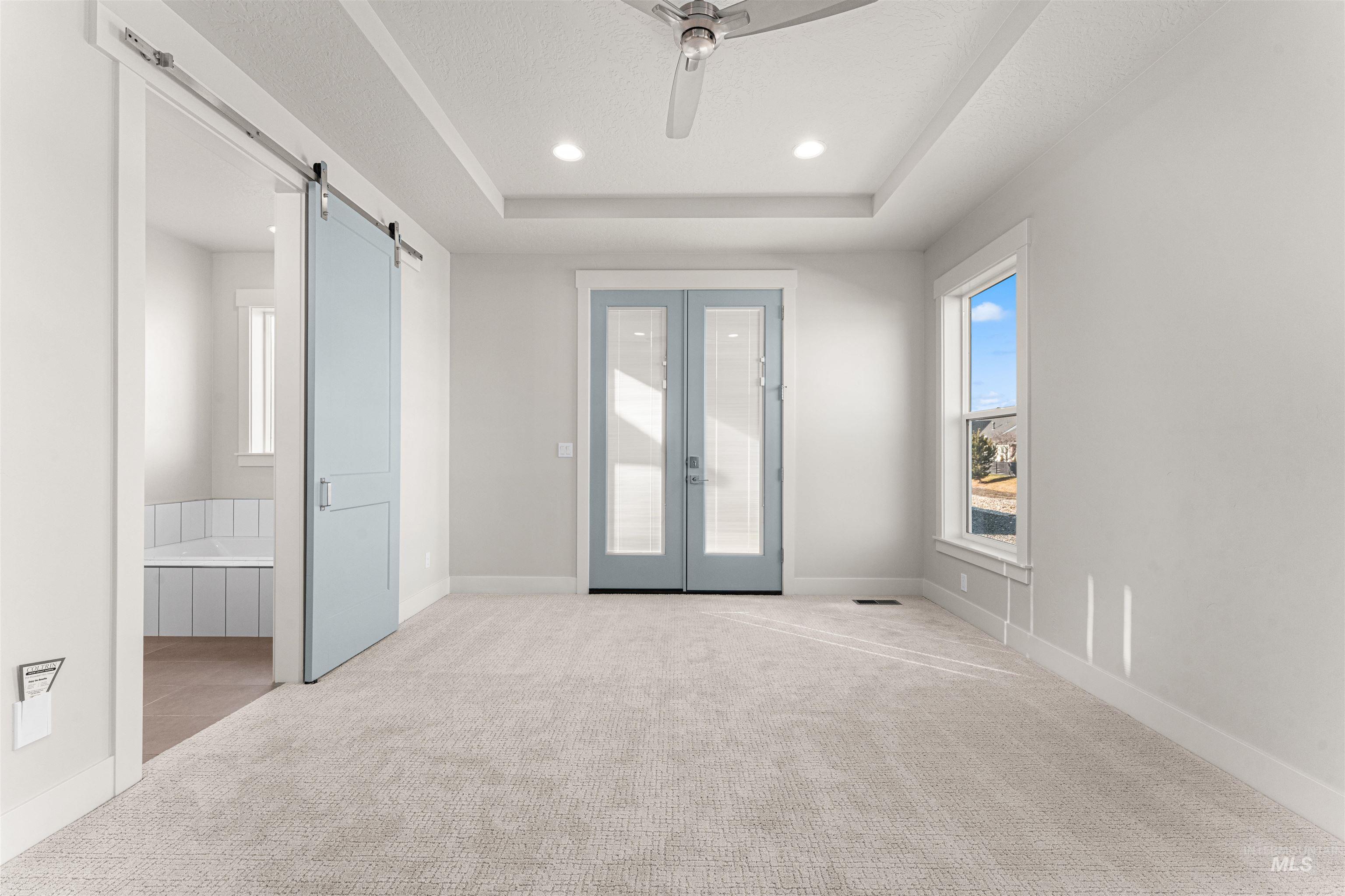 8080 Tandy Cv Street Middleton, ID 83644 - Photo 16 of 35 Foyer with carpet, french doors, a barn door, ceiling fan, and recessed lighting