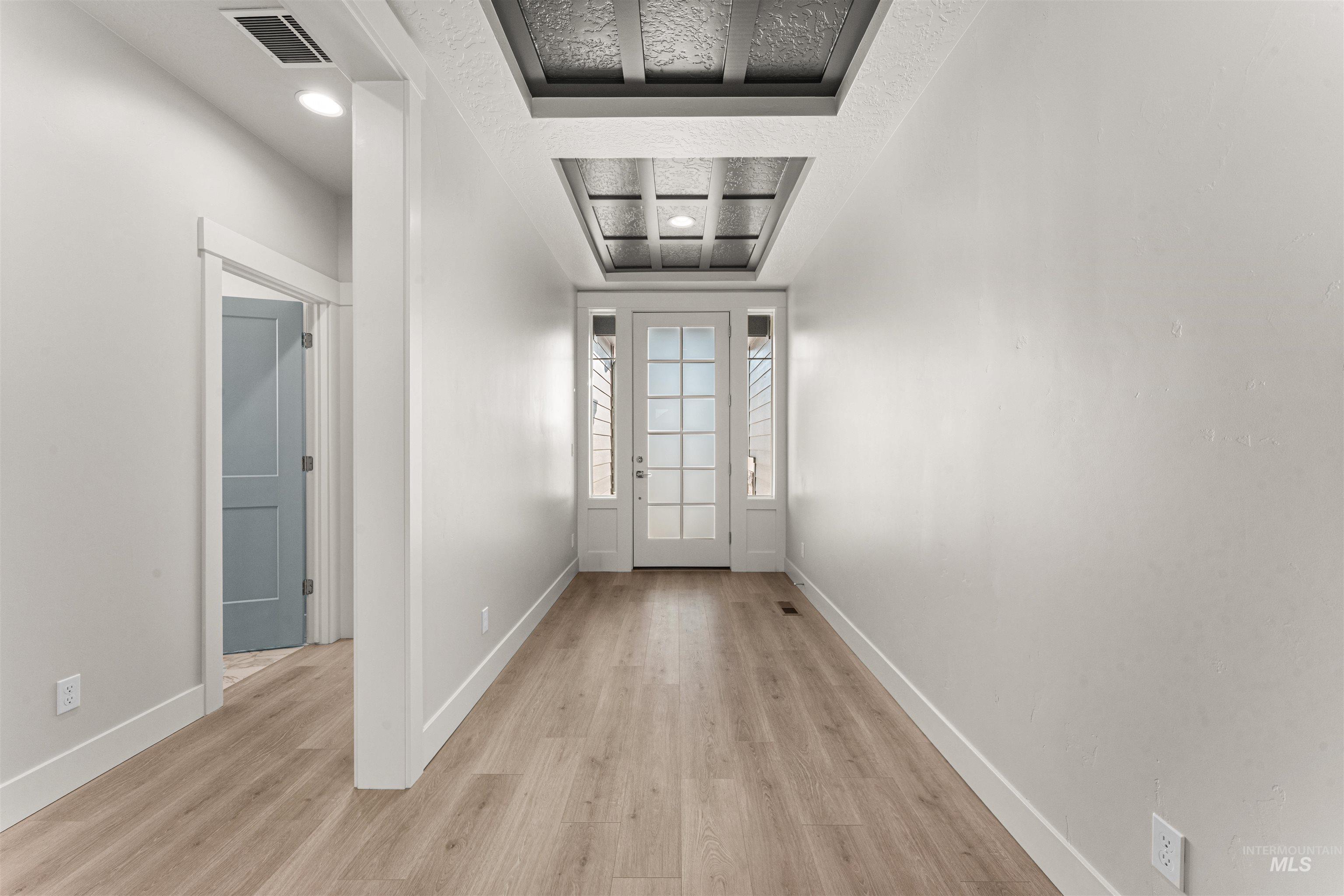 8080 Tandy Cv Street Middleton, ID 83644 - Photo 23 of 35 Doorway to outside with cooling unit, wood finished floors, and a textured ceiling