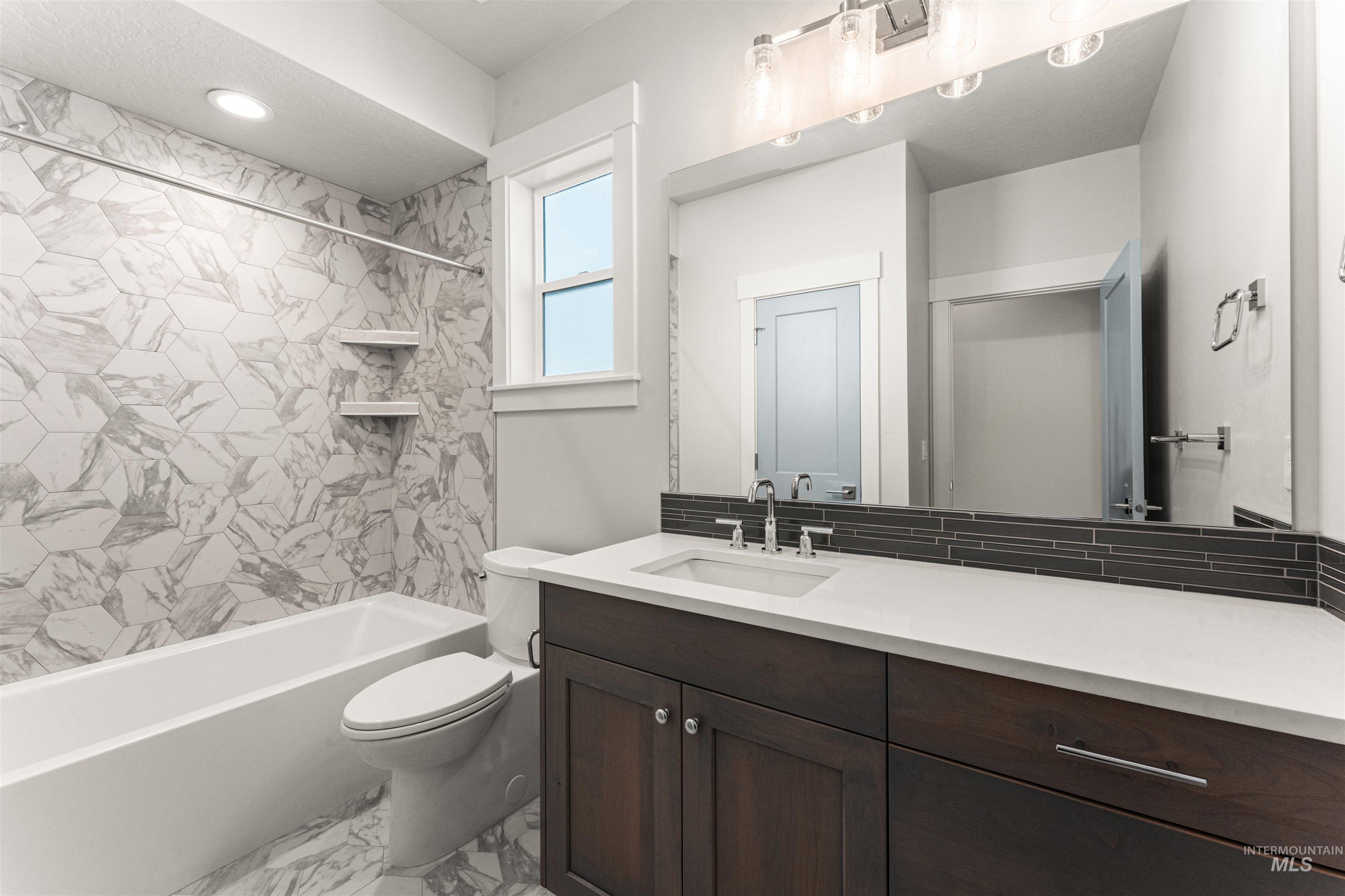 8080 Tandy Cv Street Middleton, ID 83644 - Photo 26 of 35 Bathroom with vanity, shower / bathtub combination, and light marble finish flooring