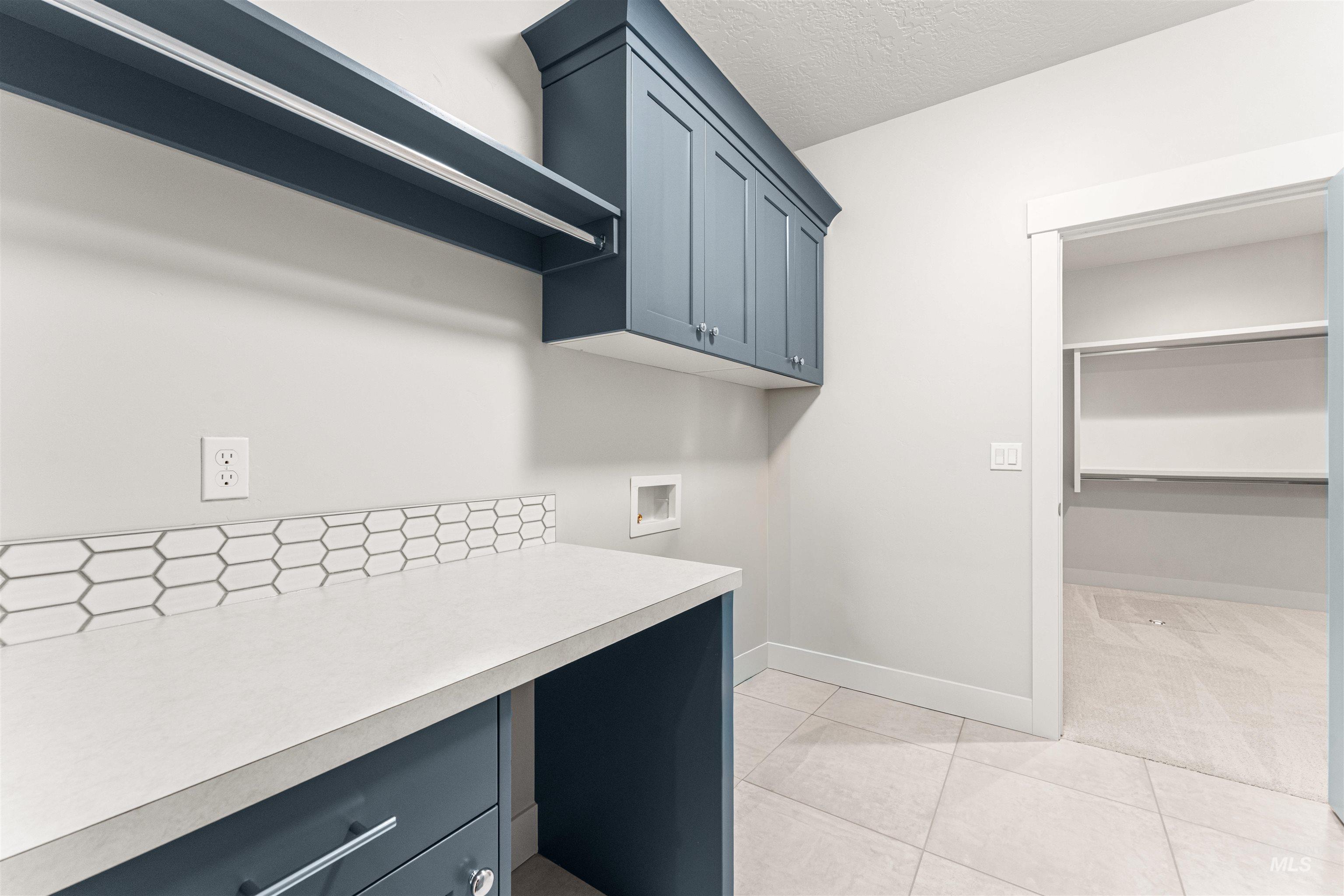 8080 Tandy Cv Street Middleton, ID 83644 - Photo 30 of 35 Laundry area with hookup for a washing machine, a textured ceiling, and light tile patterned flooring