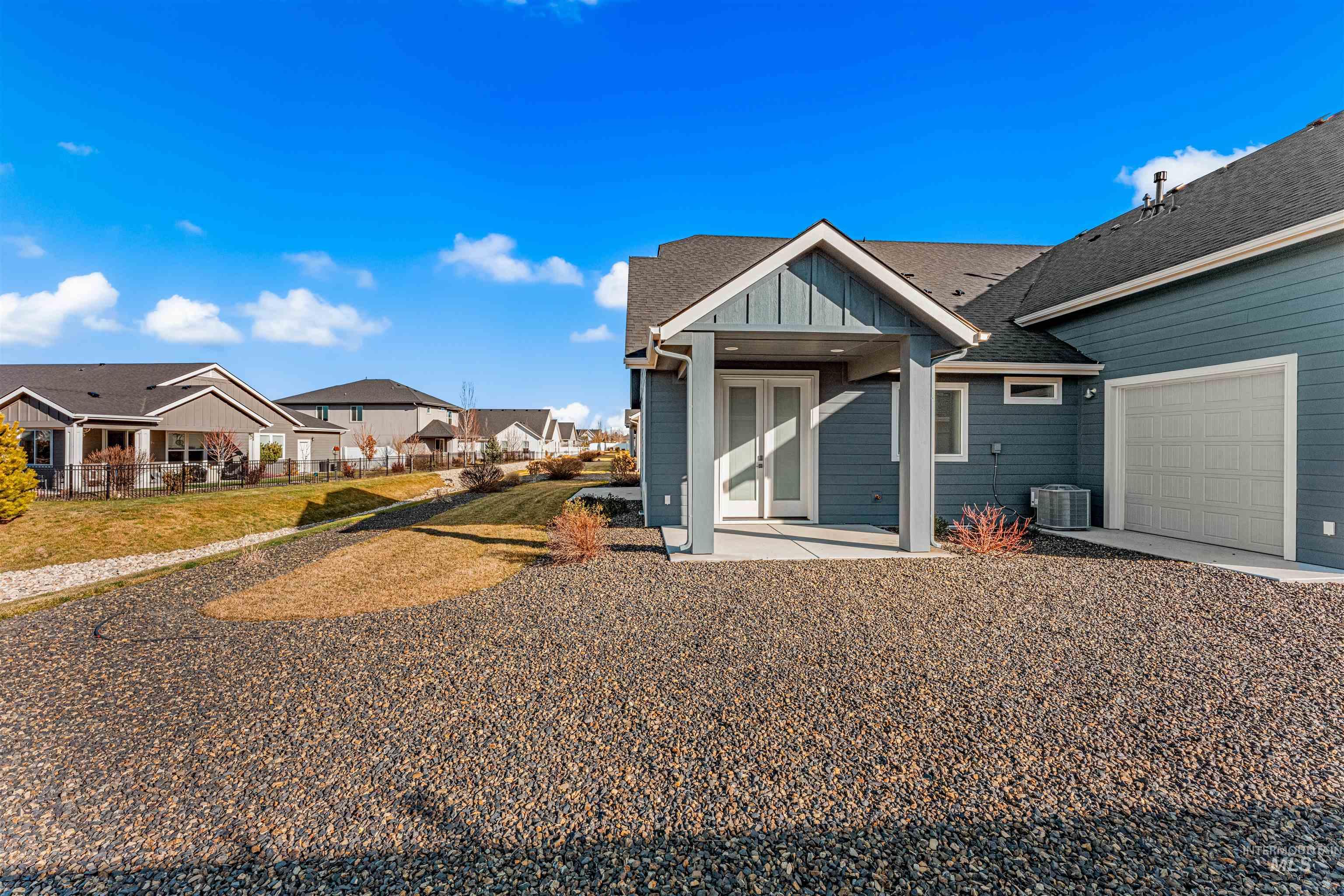 8080 Tandy Cv Street Middleton, ID 83644 - Photo 32 of 35 Back of property featuring board and batten siding, a residential view, and a shingled roof