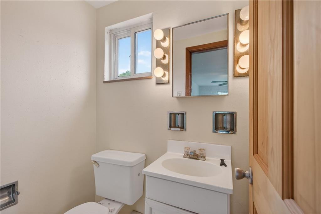 1420 Homestead Road Verona, PA 15147 - Photo 14 of 34 a bathroom with a toilet a sink and mirror