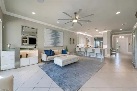 a living room with furniture and view of kitchen