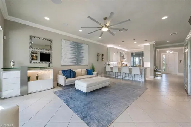 a living room with furniture and view of kitchen
