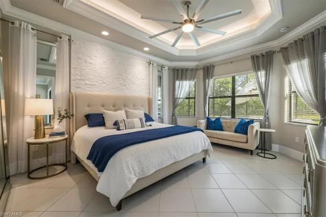 a bedroom with a bed and large window