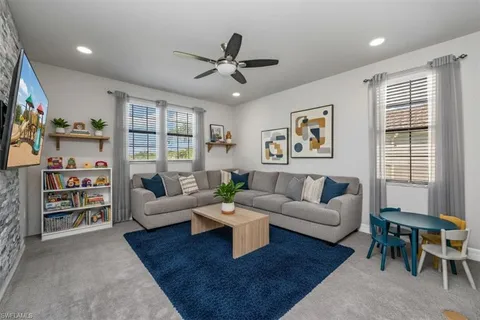 a living room with furniture and a book shelf