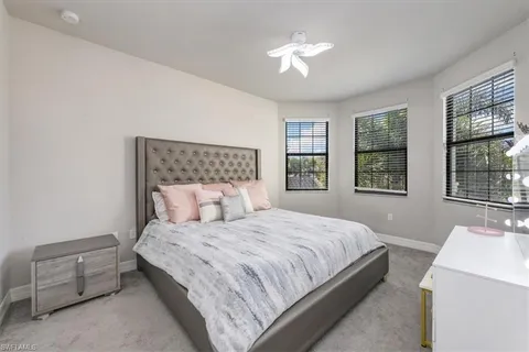 a bedroom with a large bed and a chandelier