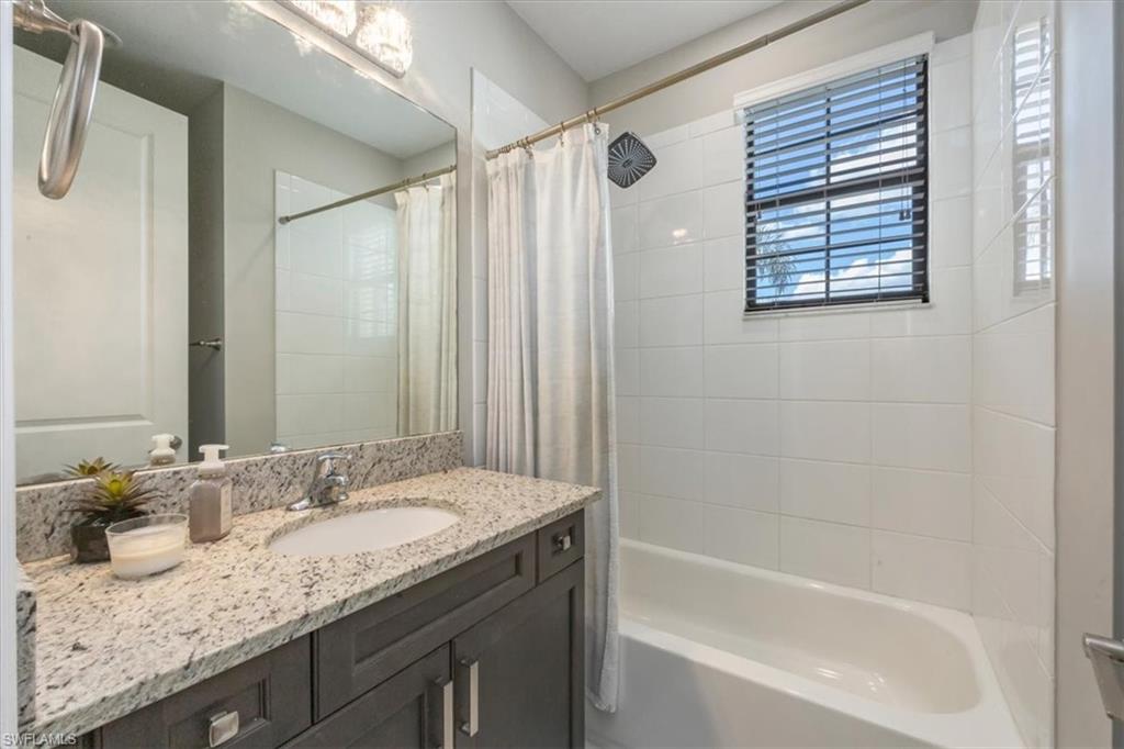 4172 Crescent Court Naples, FL 34119 - Photo 27 of 46 a bathroom with a granite countertop sink and a mirror