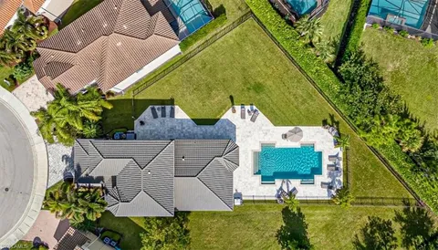 an aerial view of a house with a garden and swimming pool