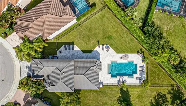 an aerial view of a house with a garden and swimming pool