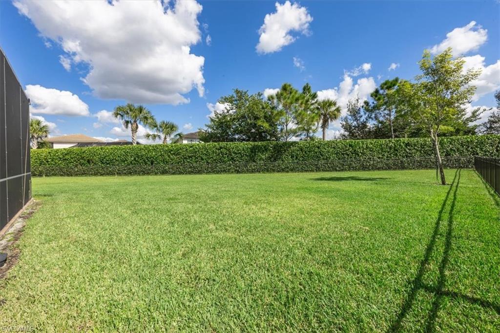 4172 Crescent Court Naples, FL 34119 - Photo 34 of 46 a view of a golf course with a lake