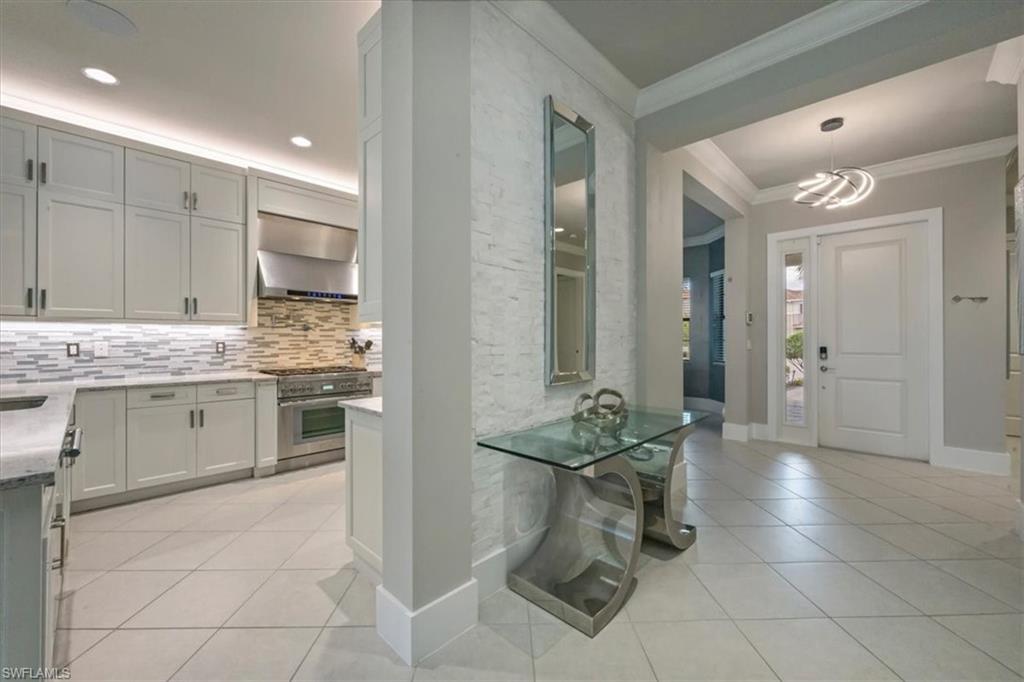 4172 Crescent Court Naples, FL 34119 - Photo 4 of 46 a kitchen with a sink cabinets and counter space
