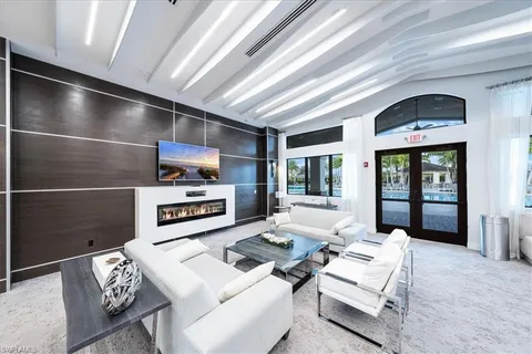 a living room with furniture a large window