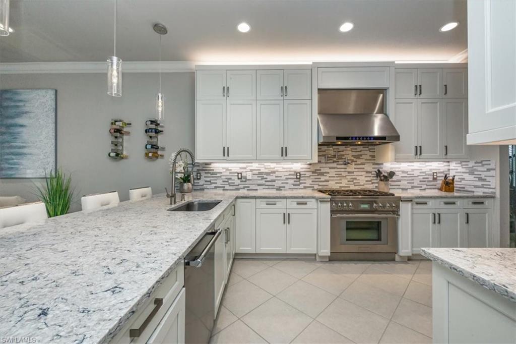 4172 Crescent Court Naples, FL 34119 - Photo 7 of 46 a kitchen with a stove sink and cabinets