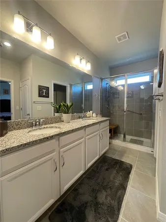 a bedroom with a bed and flat screen tv