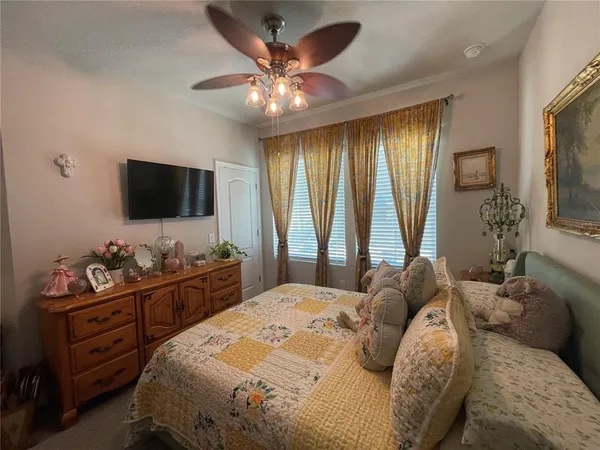 a bedroom with a bed and a chandelier