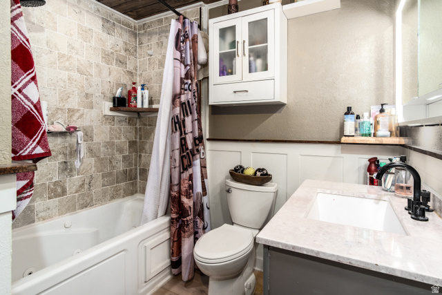 100 Third North Helper, UT 84526 - Photo 26 of 30 Bathroom with a tiled tub/shower combination, a vanity with an integrated sink, and wood-finish flooring