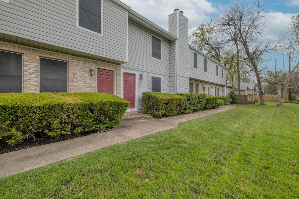 1904 Goodrich Avenue, Unit 4 Austin, TX 78704 - Photo 1 of 31 a view of a brick house with a yard and plants