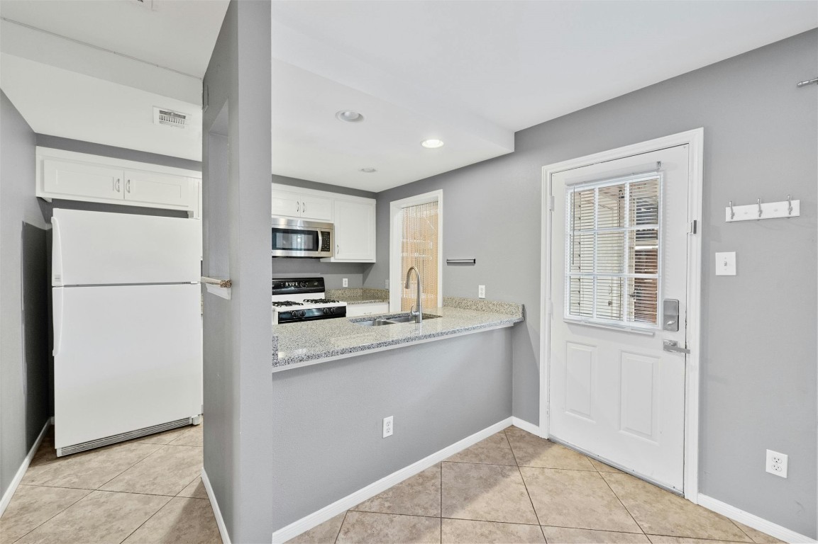1904 Goodrich Avenue, Unit 4 Austin, TX 78704 - Photo 17 of 31 a kitchen with kitchen island a sink stainless steel appliances and cabinets