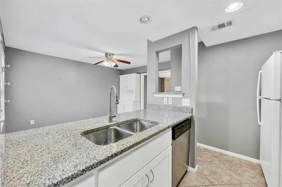 1904 Goodrich Avenue, Unit 4 Austin, TX 78704 - Photo 18 of 31 a kitchen with stainless steel appliances granite countertop a sink a refrigerator and a granite counter tops