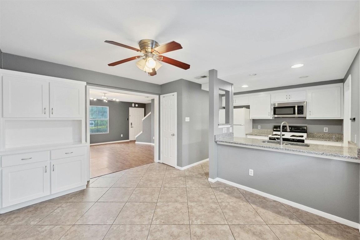 1904 Goodrich Avenue, Unit 4 Austin, TX 78704 - Photo 2 of 31 a large kitchen with stainless steel appliances a stove a sink dishwasher and a refrigerator with white cabinets