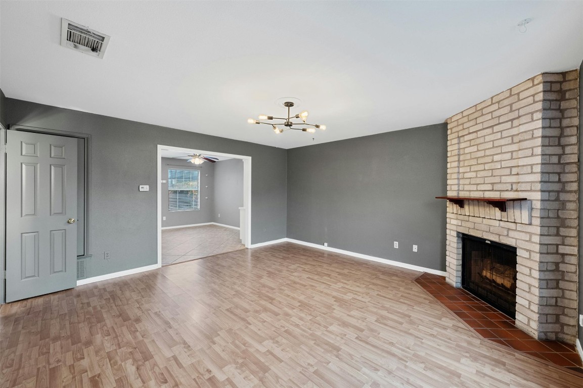 1904 Goodrich Avenue, Unit 4 Austin, TX 78704 - Photo 4 of 31 a view of an empty room with chandelier and fireplace