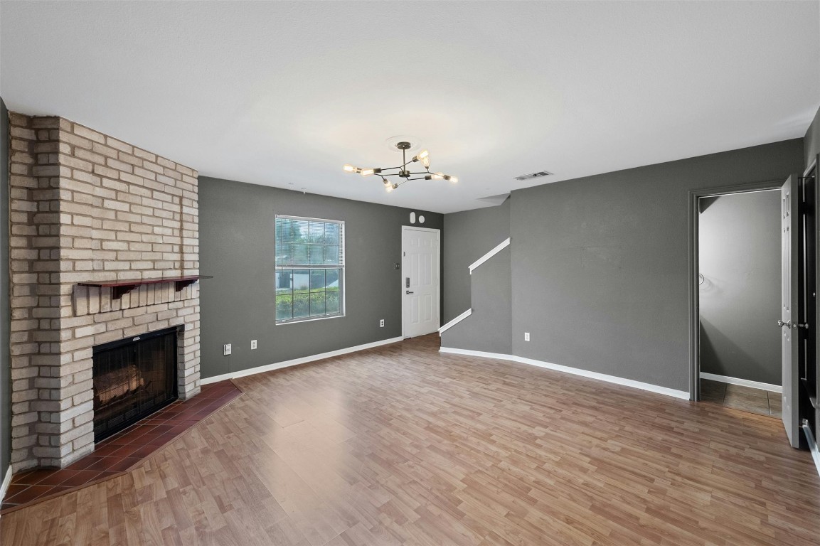 1904 Goodrich Avenue, Unit 4 Austin, TX 78704 - Photo 6 of 31 a view of an empty room with wooden floor and a fireplace