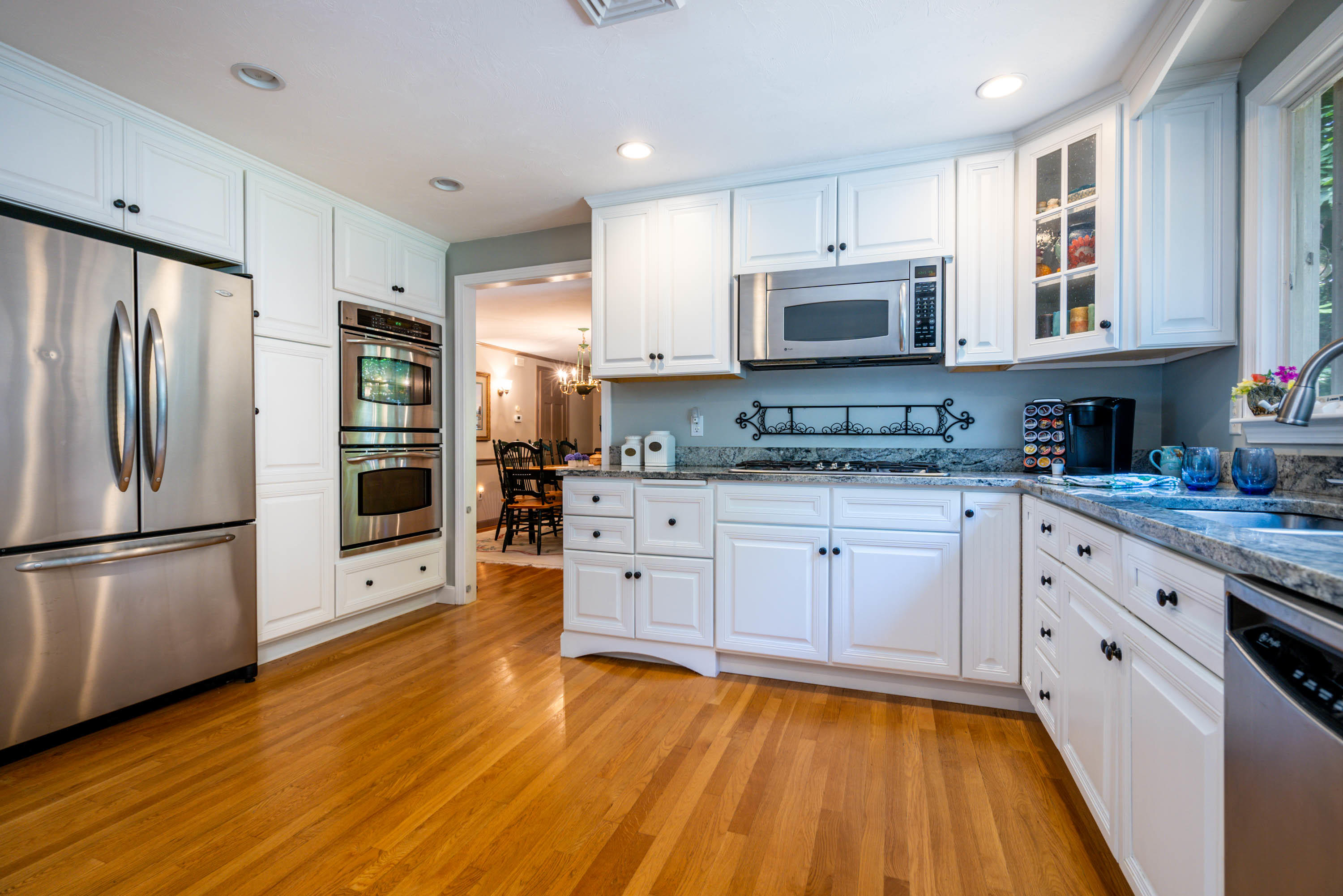 96 Breakwater Road Brewster, MA 02631 - Photo 5 of 16 a kitchen with stainless steel appliances granite countertop a refrigerator sink and white cabinets