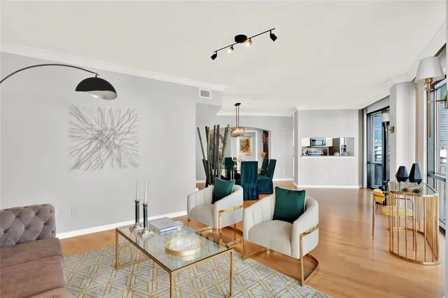 a spacious bedroom with a bed and a chandelier