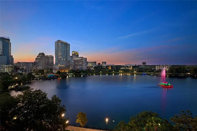 a living room with furniture and potted plants