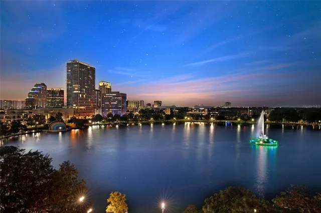 a view of a lake with boats and trees in the background