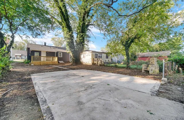 a view of a house with a yard and tree s