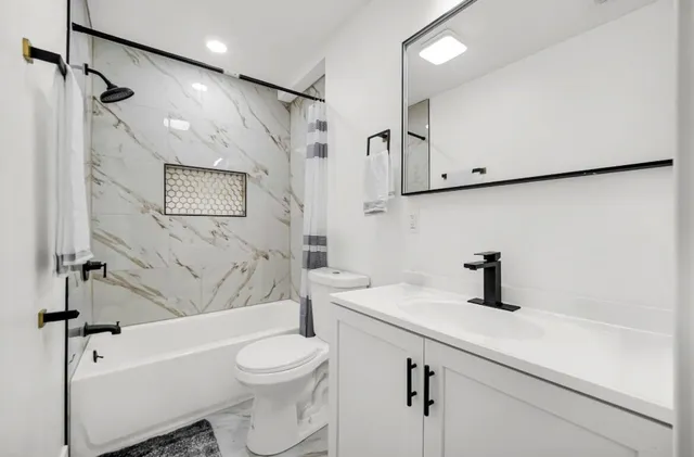 a bathroom with a sink a toilet and a bathtub