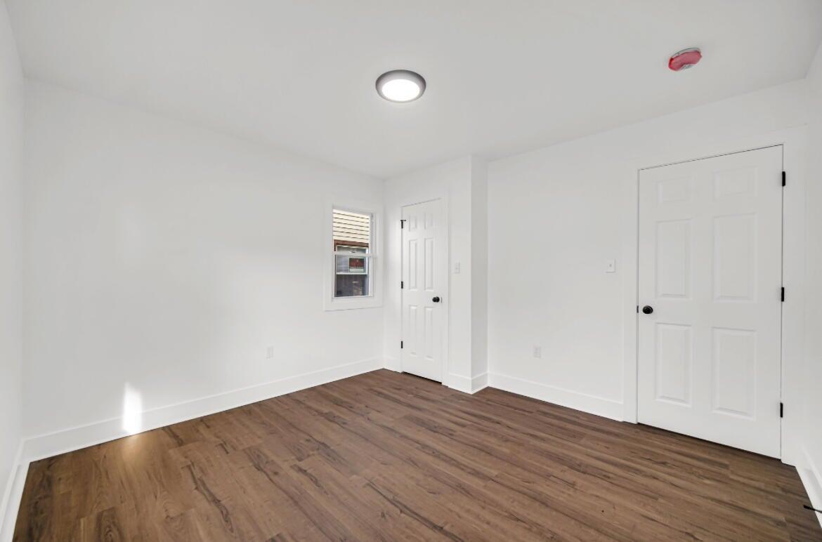 4514 East 10th Avenue Gary, IN 46403 - Photo 9 of 14 a view of a room with wooden floor and white walls