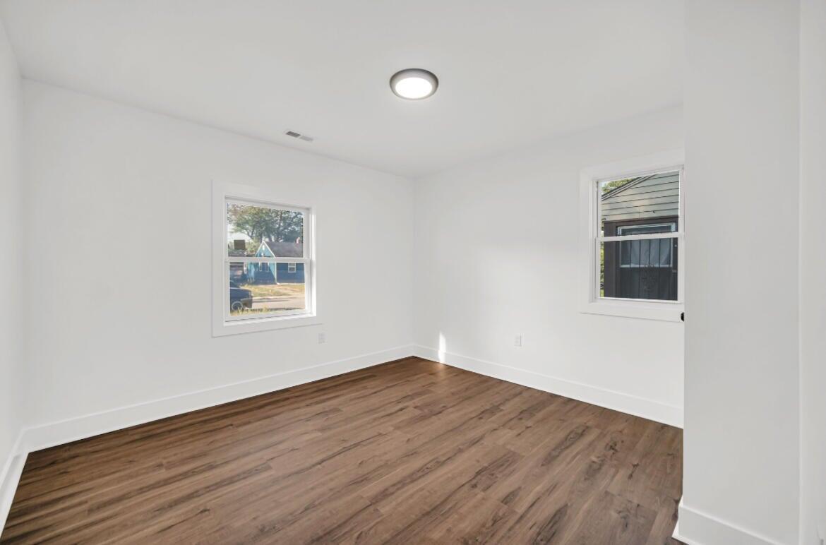 4514 East 10th Avenue Gary, IN 46403 - Photo 10 of 14 a view of empty room with wooden floor and fan