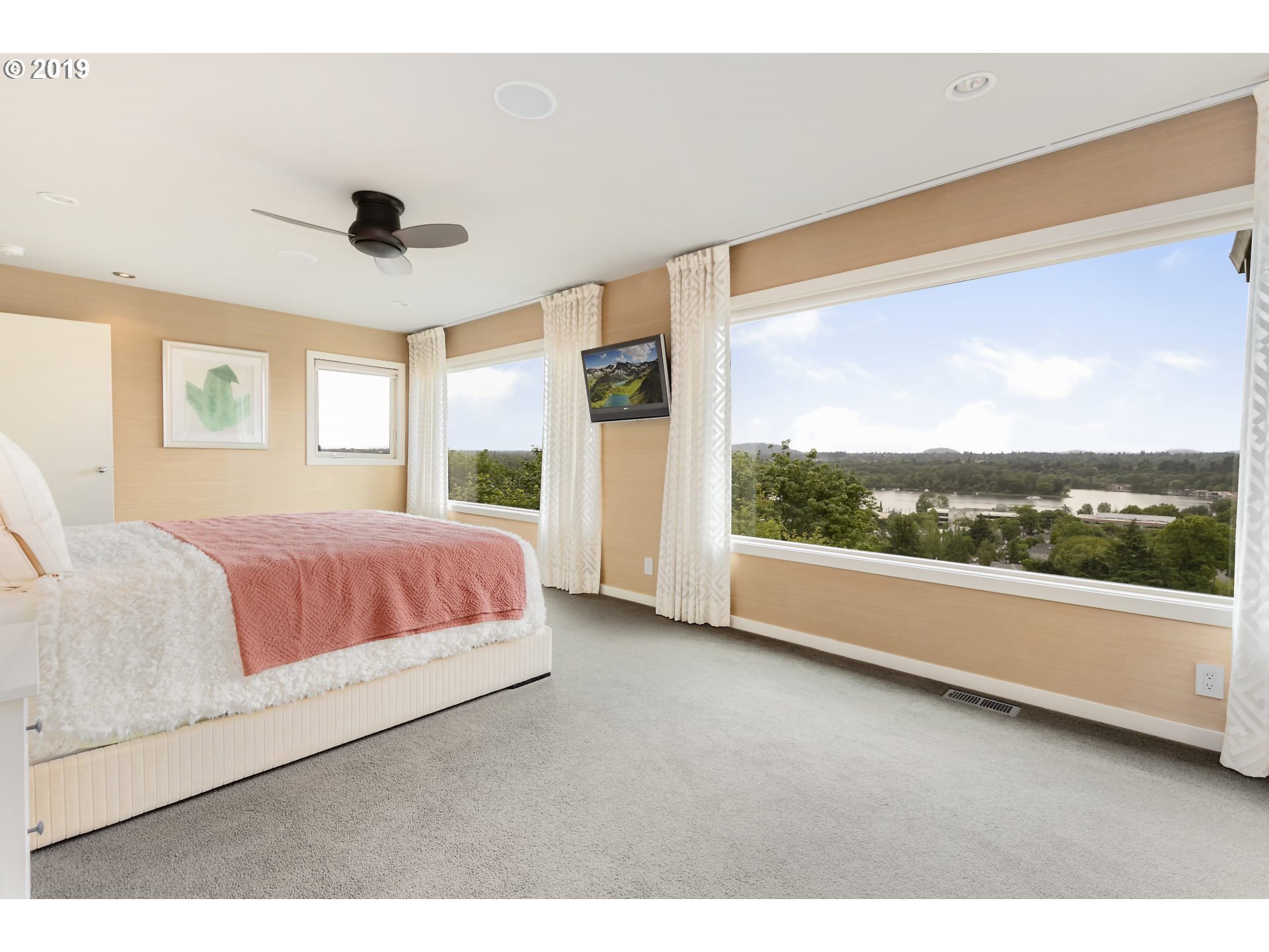 6534 Southwest View Point Terrace Portland, OR 97239 - Photo 19 of 29 a bedroom with a large bed and a large window