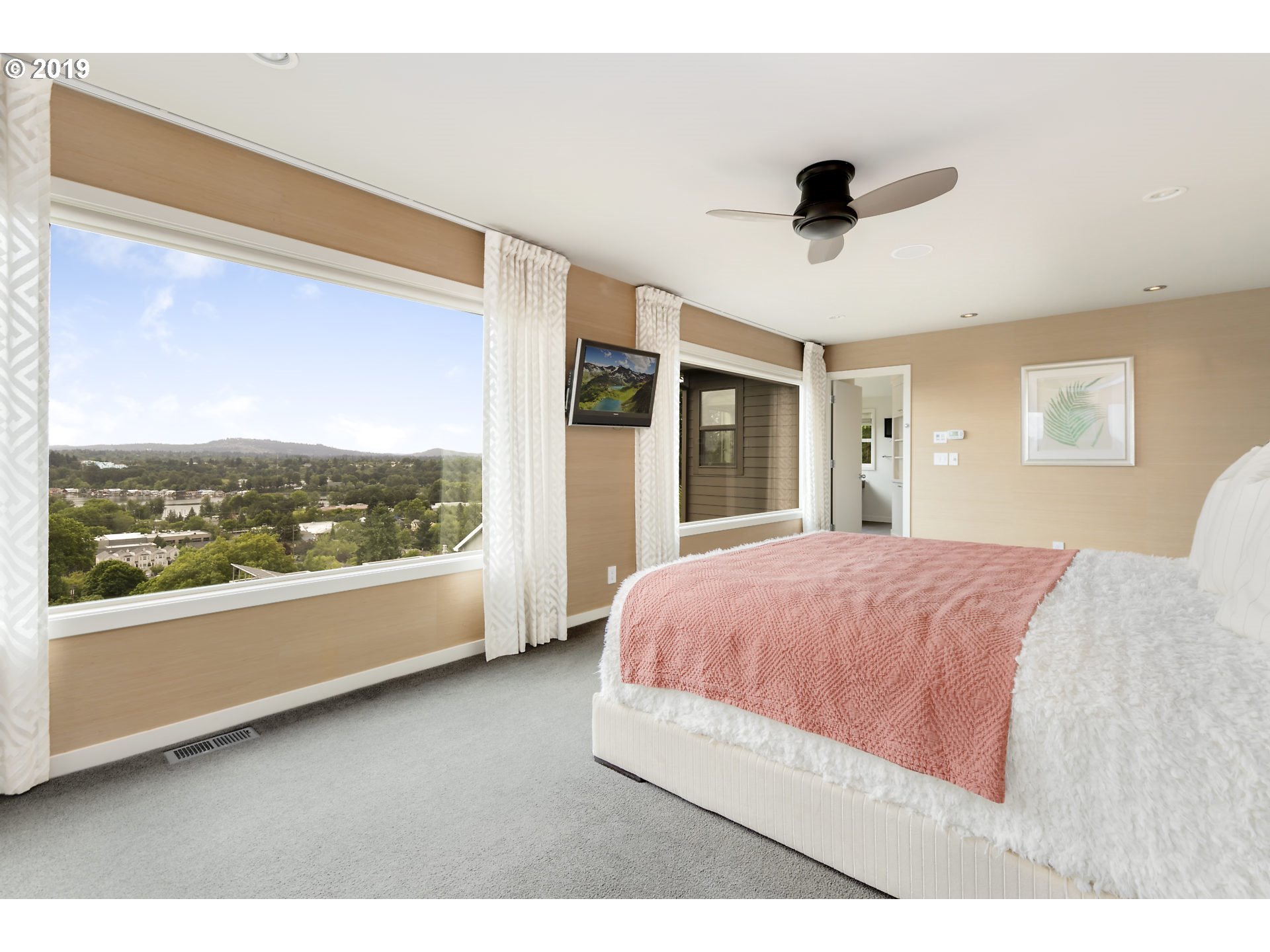 6534 Southwest View Point Terrace Portland, OR 97239 - Photo 20 of 29 a bedroom with a large bed and a large window