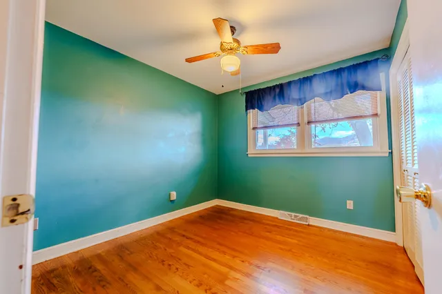 a view of a room with a fan and a window