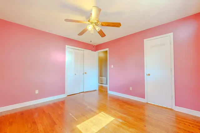 a view of a room with a chandelier fan and closet